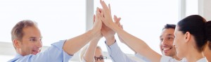 happy business team giving high five in office